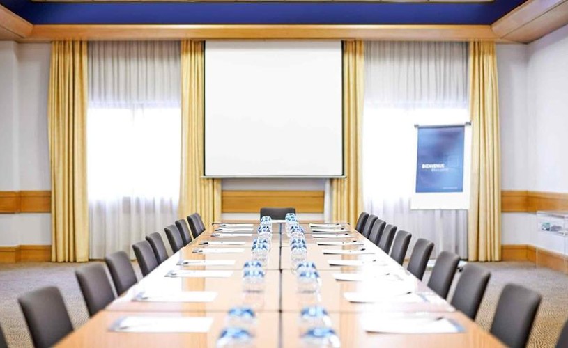 Long table and chairs set up in meeting room at Novotel Bristol City Centre